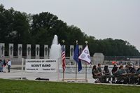 Another view of the banner and flags in front of water fountain