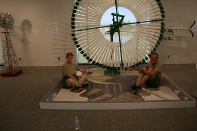 Adair And Dale Pose On An Illusion Painting Of The Top Of A Windmill